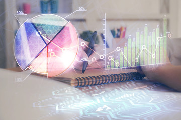 Financial graph displayed on woman's hand taking notes background. Concept of research. Double...