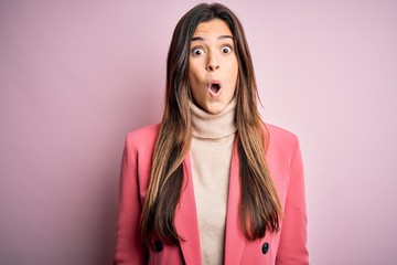 Young beautiful businesswoman wearing casual turtleneck sweater and jacket afraid and shocked with...