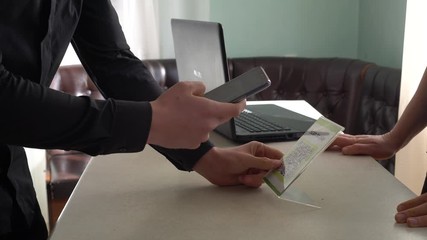 QR code mobile payment. A man scans the code displayed at the shop’s checkout, and confirm the price, before tapping to finalise the payment. Banking and payment app, online bank transfer - Powered by Adobe