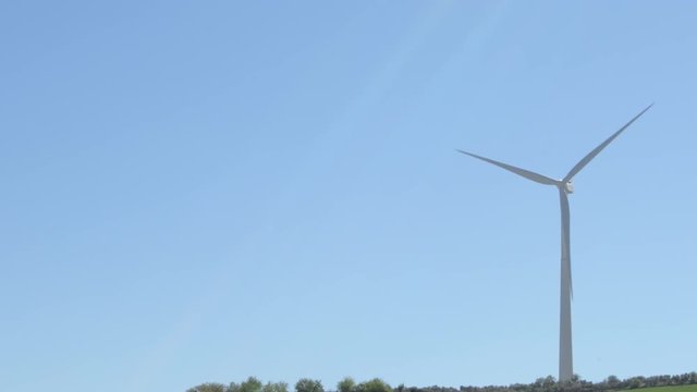 Wind turbine of renewable energy moving the blades with blue sky a sunny day