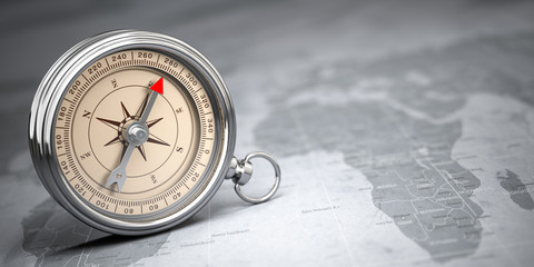 Compass on vintage old map.  Travel geography navigation and adventure concept background.