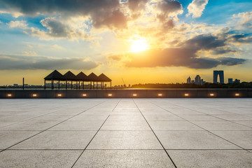 Empty square floor and beautiful city skyline with buildings at sunset in Suzhou.