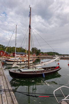 Finland, Aland Islands, Lappo, Lappo island on the archipelago of the Aland Islands in the very south of Finland. vertical frame, pier and old sailing ship