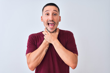 Young handsome man standing over isolated background shouting and suffocate because painful strangle. Health problem. Asphyxiate and suicide concept.