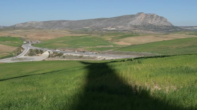 Shadow of wind turbine of renewable energy moving in the field