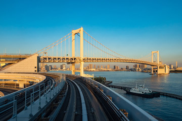 Japan. Railway tracks and rainbow bridge in Tokyo. Transport system of the capital of Japan. Rainbow bridge on the background of Odaiba island. Artificial Islands in Tokyo. Guide to Japan.