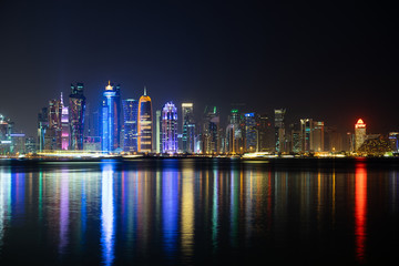 Fototapeta premium Vibrant Skyline of Doha at Night as seen from the opposite side of the capital city bay at night