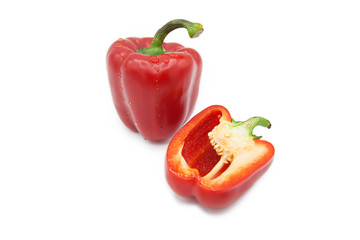 Ripe fresh organic bell peppers and half pepper in dew drops isolated on a white background