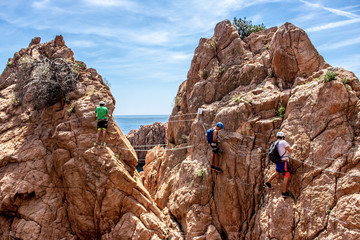  Rock climbers on the beach of Sant Feliu de Guixols