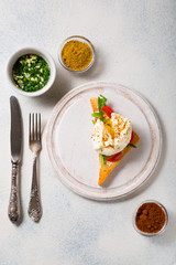 Poached egg, fried toast and greens on a white background. French breakfast.