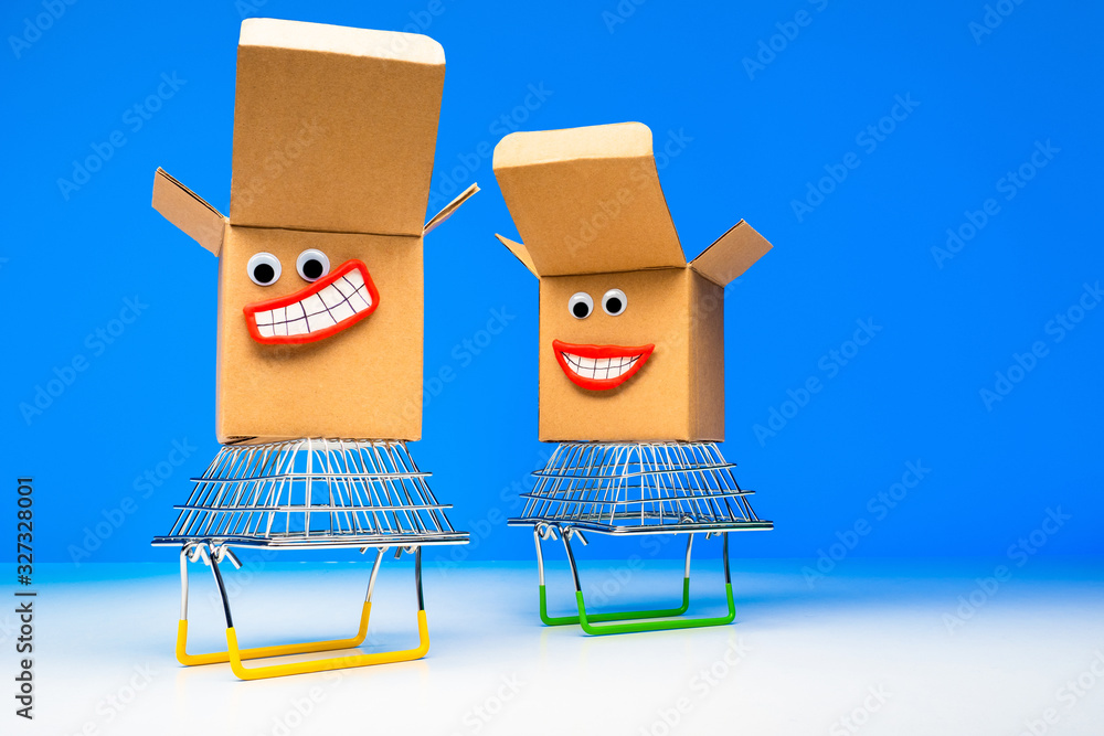Poster cardboard boxes with faces on a blue background. boxes stand on inverted shopping baskets. purchases