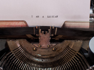 close-up text I AM A LESBIAN. old vintage typewriter with a sheet of white paper