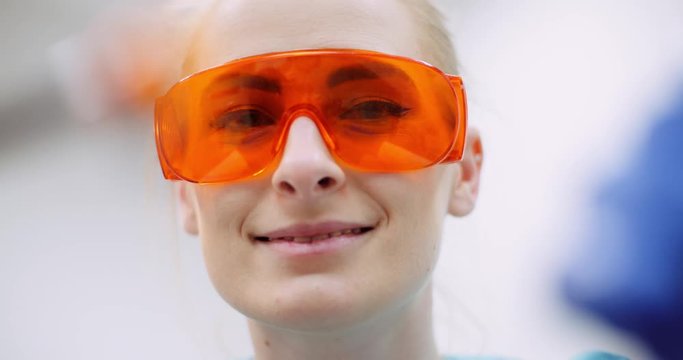 dentist using UV hardener during surgey at healthcare clinic