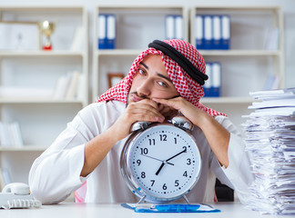 Arab businessman working in the office doing paperwork with a pi