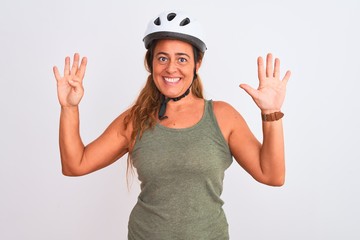 Middle age mature cyclist woman wearing safety helmet over isolated background showing and pointing up with fingers number nine while smiling confident and happy.