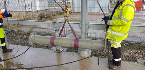riggers moving pipe using two chain blocks 