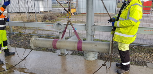 riggers moving pipe using two chain blocks 
