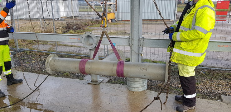 riggers moving pipe using two chain blocks 