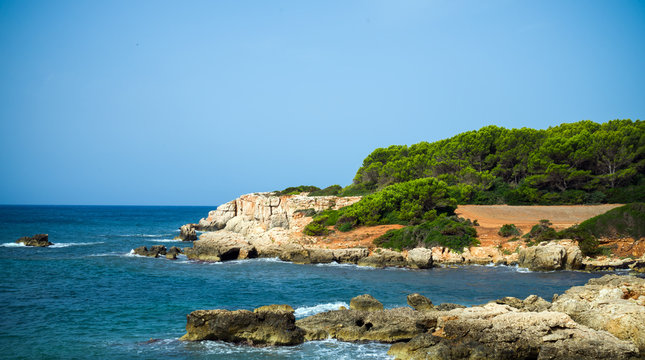 Sea coast hiking path with beautiful sea view in Atalis nature park near Sant Tomas in Menorca island