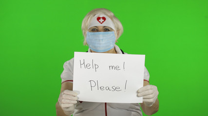 Elderly female doctor in medical mask show page with message. Coronavirus