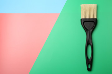 Paintbrush on multicolored background