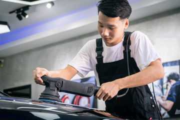 Car cleaning auto service : the man cleaning and polishes. car detailing concepts. Selective focused