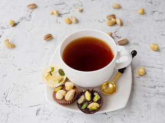  black tea with sweets on the background