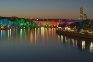 Photography of illuminated colorful public park Sparrow Hills / Vorobyovy Gory / Lenin Hills in winter night Moscow. Concepts of beauty of bright big city.