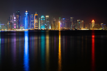 Fototapeta premium Vibrant Skyline of Doha at Night as seen from the opposite side of the capital city bay at night