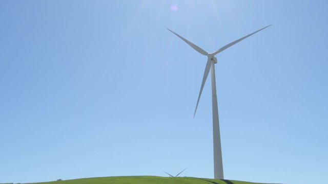 Big wind turbine moving blades with blue sky a sunny day