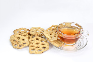 Kuih Cincin rice flower brown sugar sweet cracker snacks with cup of transparent licker tea