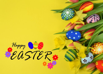 Happy Easter - painted eggs and daffodils on colored background