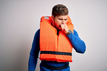 Young blond tourist man with beard and blue eyes wearing lifejacket over white background feeling...