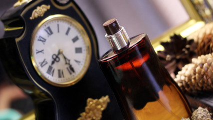 beautiful bottle of perfume and retro clock