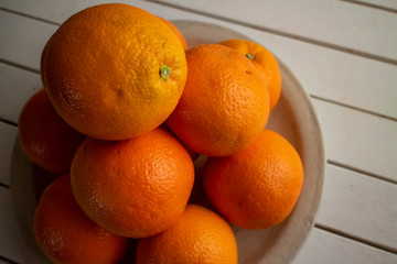 白い陶器の上のたくさんのオレンジ Various fresh oranges on a white ceramic plate 3