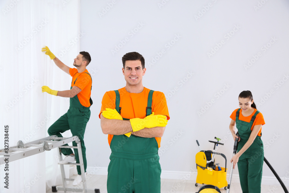 Poster team of professional janitors cleaning room after renovation