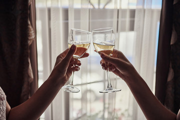 Cheers! Photo bride with her friends drinking champagne from glasses