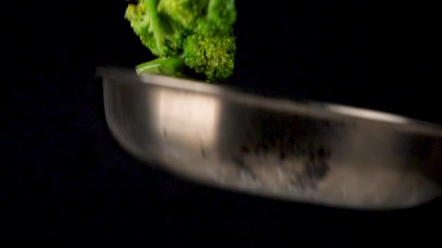cooking vegetable in pan, broccoli and carrot , slow motion