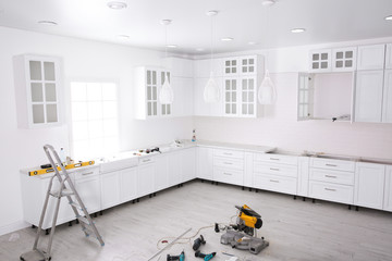 Renovated kitchen interior with stylish furniture and maintenance equipment