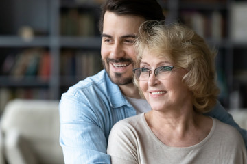 Fototapeta premium Hopeful senior mom and adult son visualize together