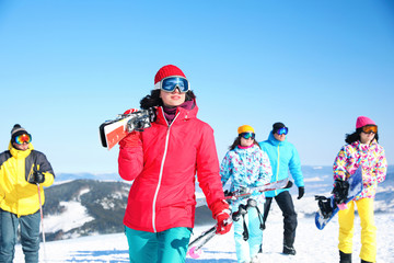 Young woman with ski at resort. Winter vacation