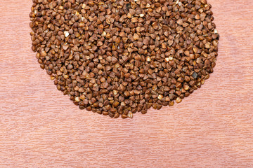 raw buckwheat on a wooden background