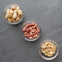 Top view of three bowls of peanuts, healthy snack