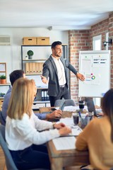 Obraz premium Group of business workers working together in a meeting. One of them making presentation to colleagues at the office