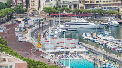 Seaside swimming pool in Monaco timelapse, with people and buildings in the background.