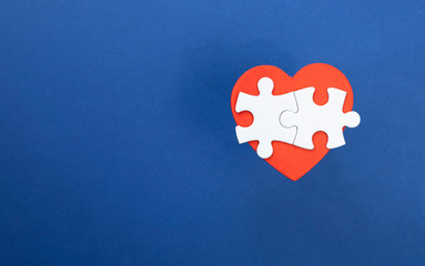 Red heart and puzzle pieces.