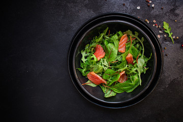 healthy salad leaves mix, salmon or tuna (delicious snack) pescatarian, keto or paleo diet menu concept. food background. top view. copy space