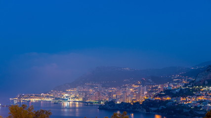 Fototapeta na wymiar Cityscape of Monte Carlo night to day timelapse, Monaco before summer sunrise.