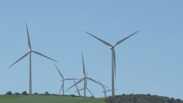 Wind turbines of renewable energy moving blades a sunny day