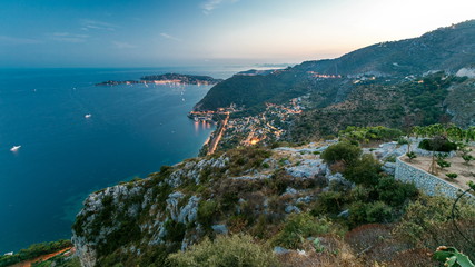 Fototapeta na wymiar Day to night timelapse view of the Mediterranean coastline of the town of Eze village on the French Riviera
